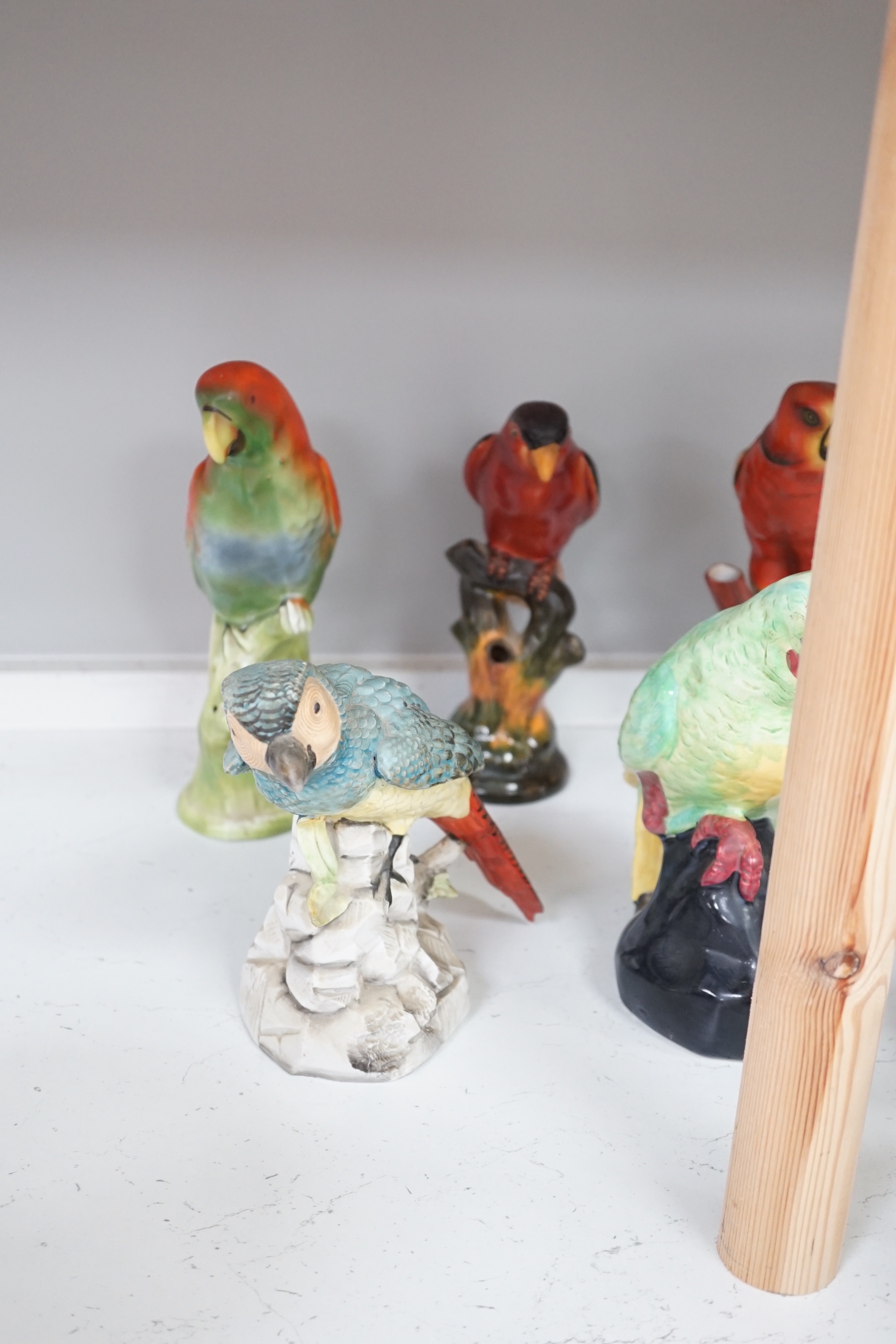 A group of twelve ceramic parrots including one by S Hancock & Sons, largest 24cm high